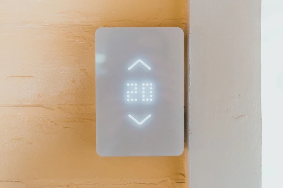 Panel de llamada de ascensor en el hall de un edificio, con el indicador de piso encendido; fotografía de Erik Mclean en Pexels.